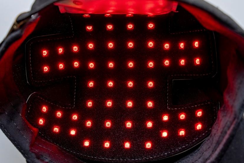 Interior of a red light therapy laser cap with LEDs illuminated